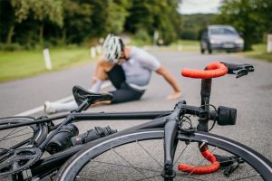 Injured bicyclist on pavement